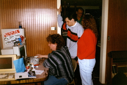 Endo sits at our single computer with a dial-up connection while Steve and Liza look on.
