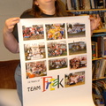 Joyce showing off a poster of team pictures